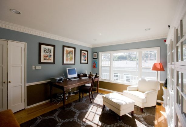 trendy home office with a narrow wooden dining table as a desk