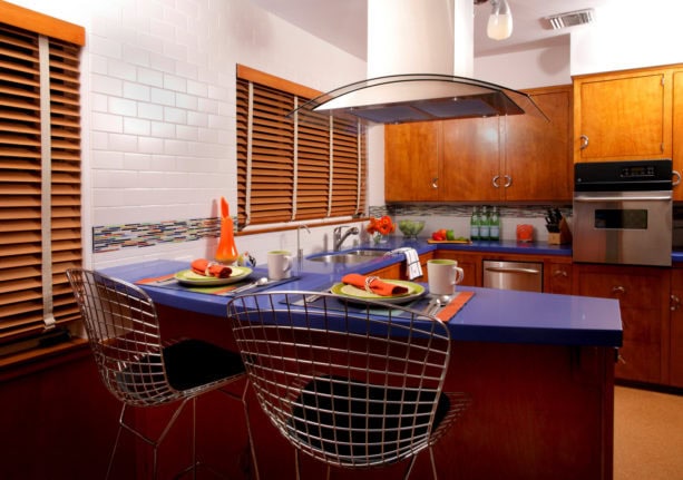 unique combination of brown flat-panel cabinets and cobalt blue countertop kitchen color to give a bold look