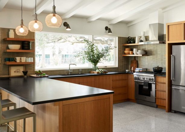 black countertops and green backsplash kitchen color combined with brown flat-panel cabinets for an elegant yet refreshing look