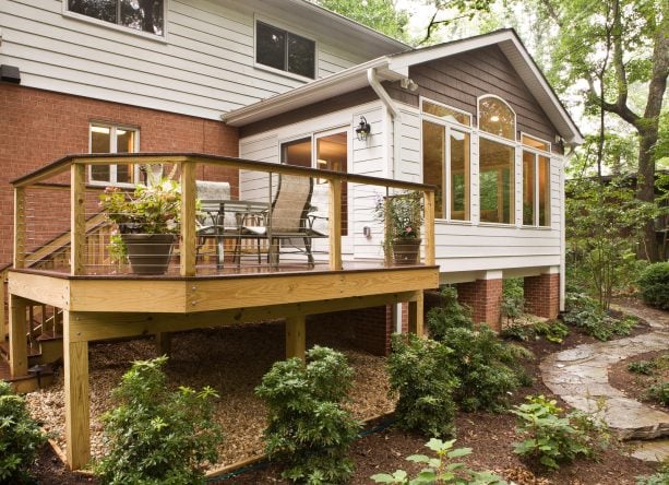 pea gravel ground cover with wood edging in an under deck landscaping