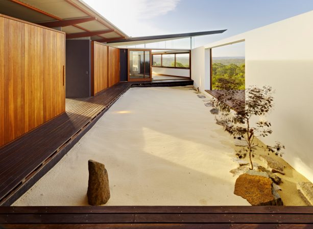 rectangular-shaped zen garden with smattering large rocks without bushy plants