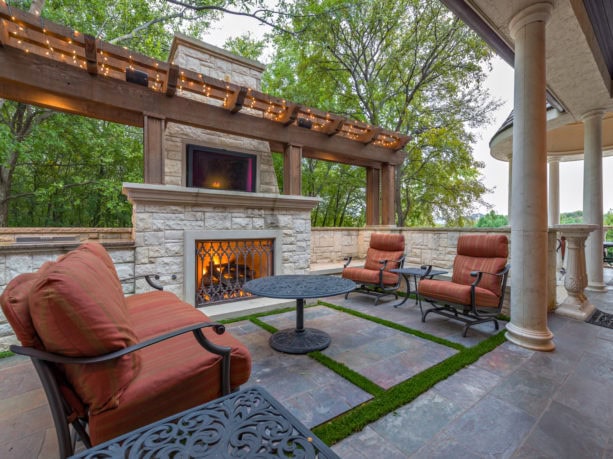 pavilion with travertine decking and outdoor fireplace completed with 42 inch tv