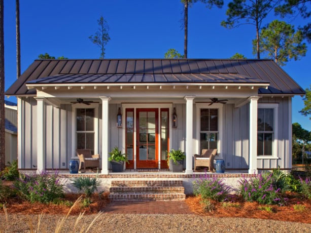 custom color house exterior with white trim and medium bronze metal roof combination