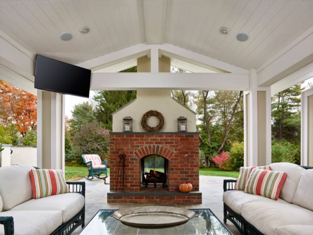 flagstone covered patio with brick wood burning fireplace