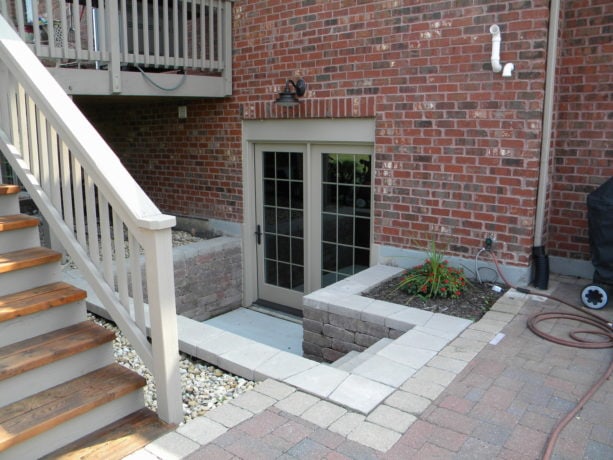 2 panel bi-fold walkout basement door option in a red brick wall