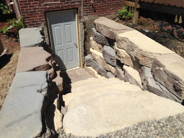 gray hinged walkout basement door option for a rustic exterior