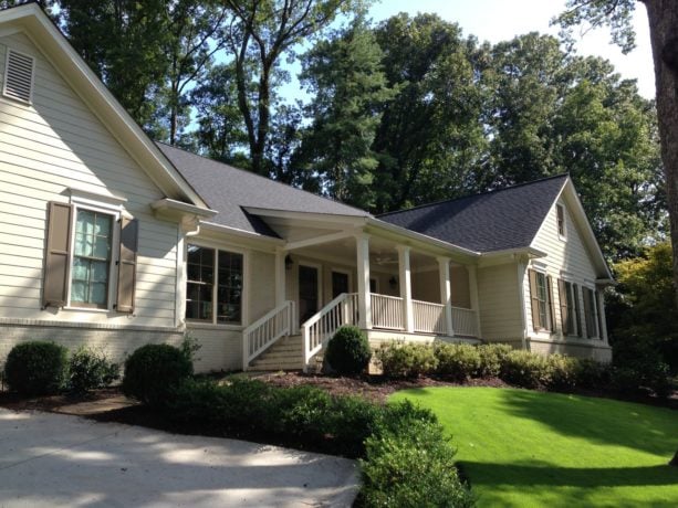 creamy white ranch style home with an elevated timeless front porch