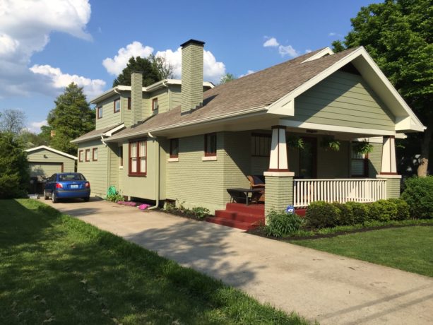 simple sage green house with syrup brown trim