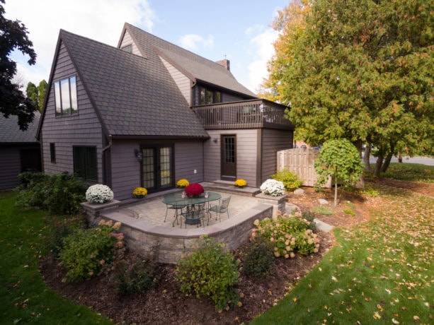 transitional patio in a small backyard with the concrete paver