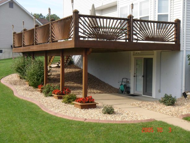 low maintenance gravel under deck landscaping with plants in the perimeter