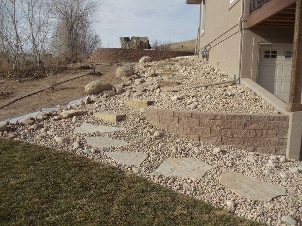 prairie-inspired garden with river rock walkway and without plants at all