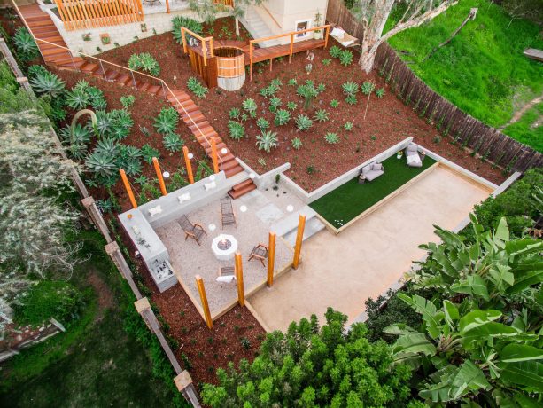 sloped under deck landscaping with soil and decorative plants