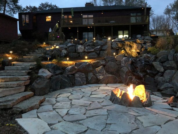 tri-level garden with large rocks and boulders as retaining walls and stone staircase