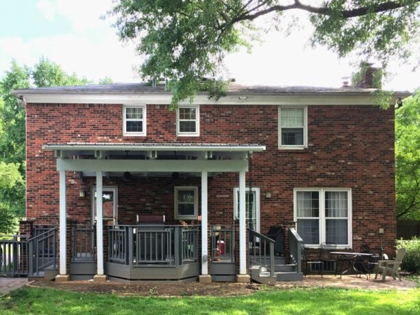 minimalist and elevated small back porch with a railing