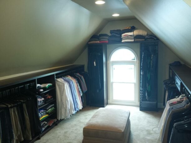 timeless attic closet with hanging racks bracketing the window