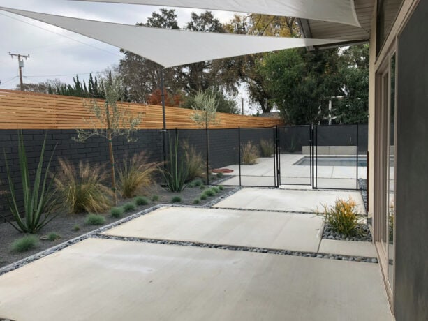 dark mid-century modern fence with light wood panel extension