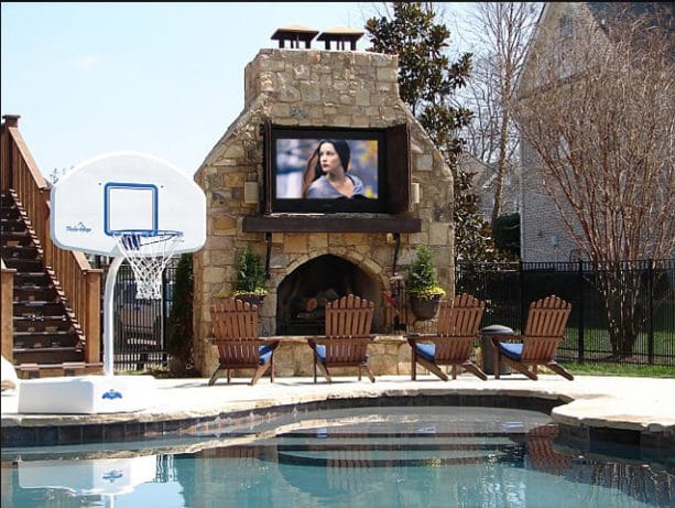 large outdoor fireplace completed with a weatherproof 65 inch tv