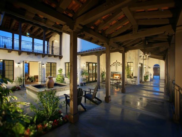 spanish style split-level home featuring a courtyard with a fountain