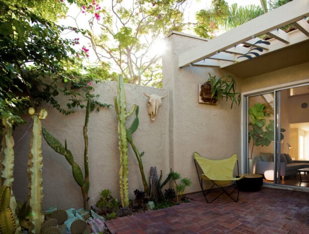 brick townhouse patio with greeneries to contrast it