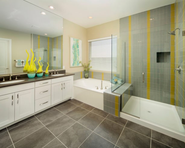 the use of grey and yellow glass tiles for a shower room’s walls