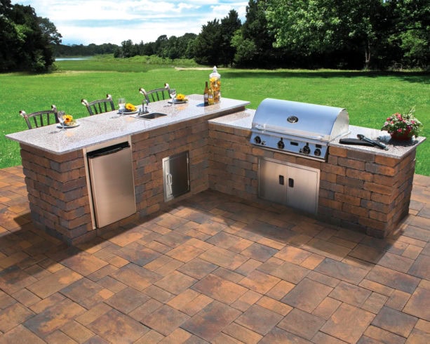 uncovered l-shaped outdoor kitchen and bar with polished granite countertops