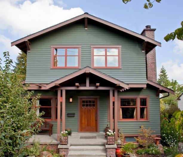 lovely moss green house with wooden nutmeg brown trim