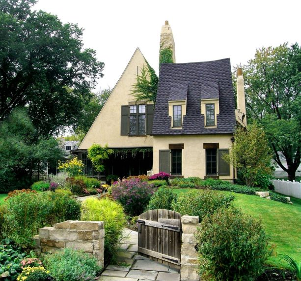 soft yellow wall house exterior combined with a black shingle roof