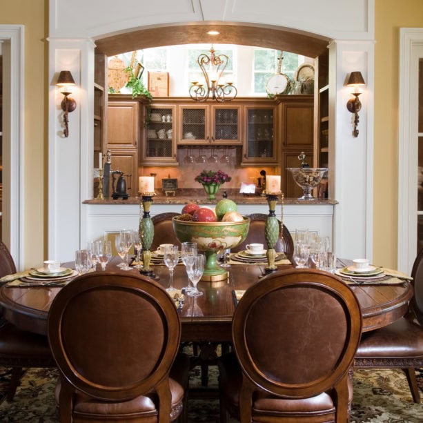 mid-sized elegant dining room side by side with a semi-enclosed bar