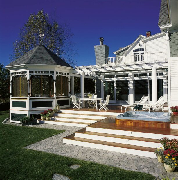 victorian styled gazebo next to a pergola on a deck