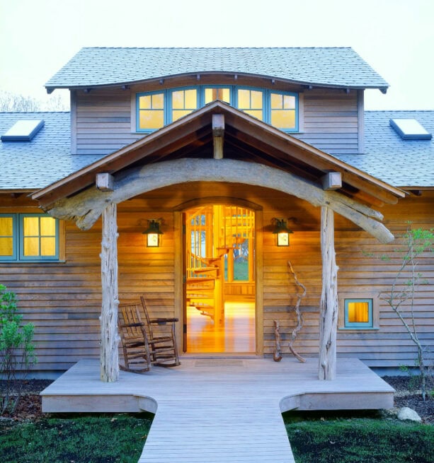 a single rocker in a small decking log cabin porch made of driftwood timbers