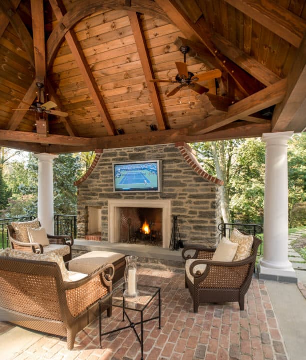 timber framing pavilion with wide fireplace and tv