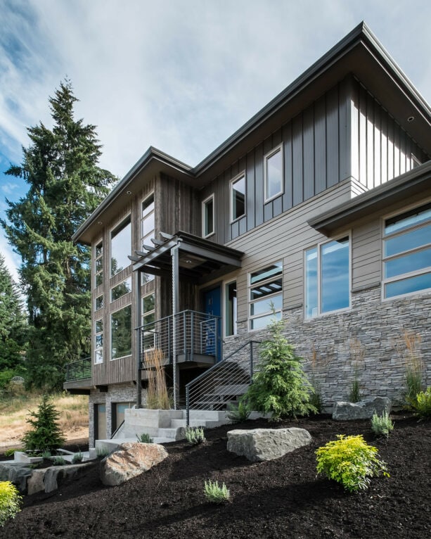 vertical metal roofing as one of the mixed sidings of a three-story house