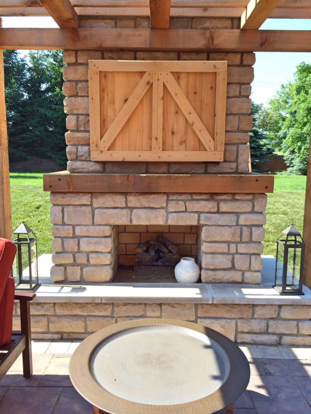 rustic style outdoor fireplace with custom tv cabinet