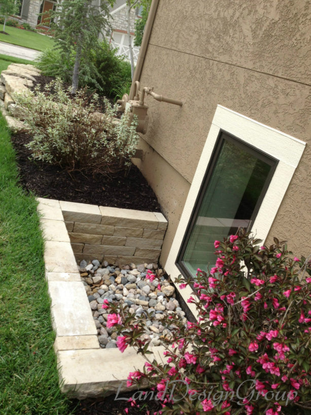 extra-low basement window well made of natural stone