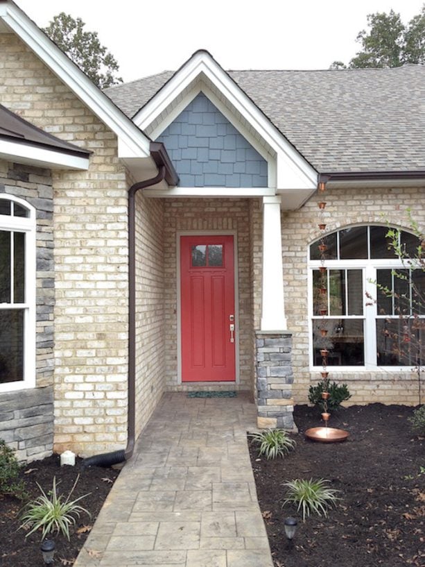 creating a whimsical look using a pink coral front door paired with blue-gray cedar shakes