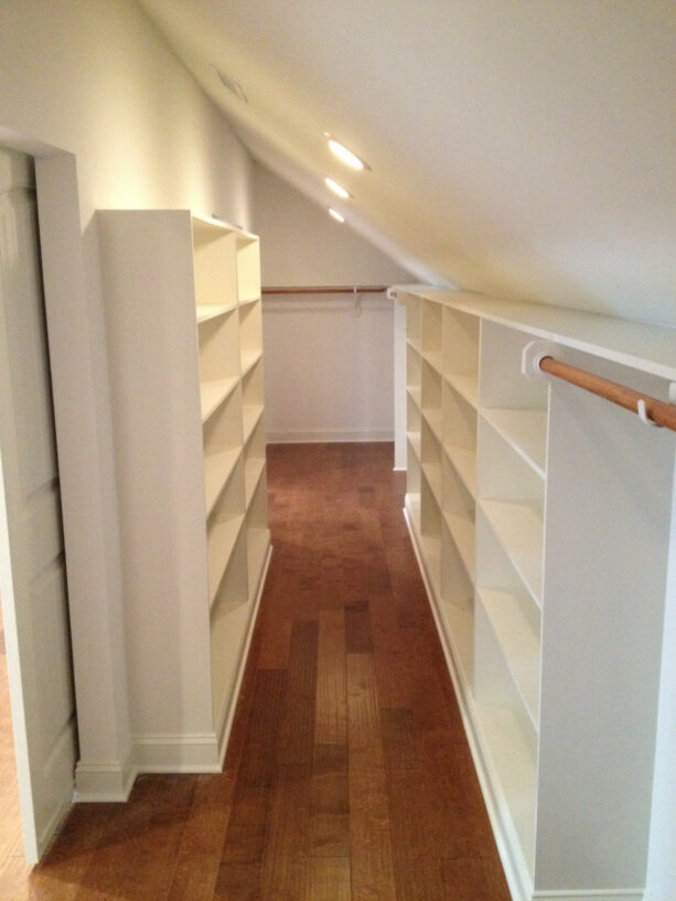 white cabinets in a super tiny attic closet