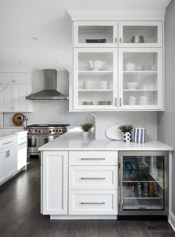 dark brown floors paired with white matte backsplash and kitchen cabinets