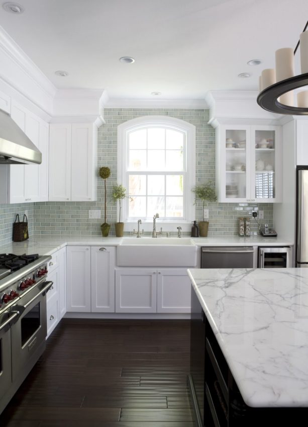 dark hand scraped hardwood floor paired with white carrara marble tops and cabinets