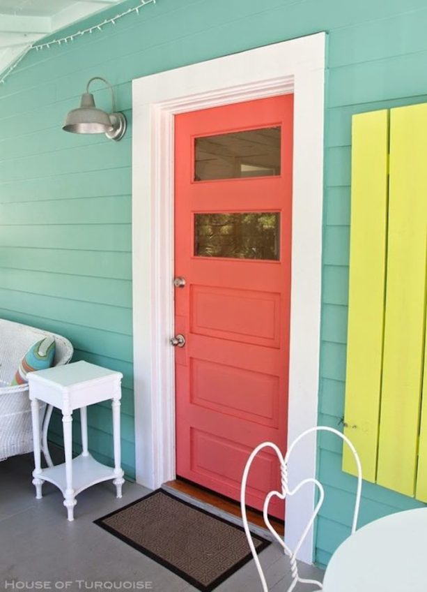 eclectic entrance with coral front door and blue-yellow color scheme