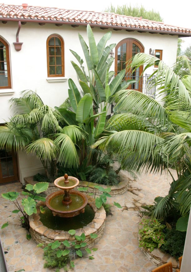 spanish style two-story home remodel with a stamped concrete courtyard