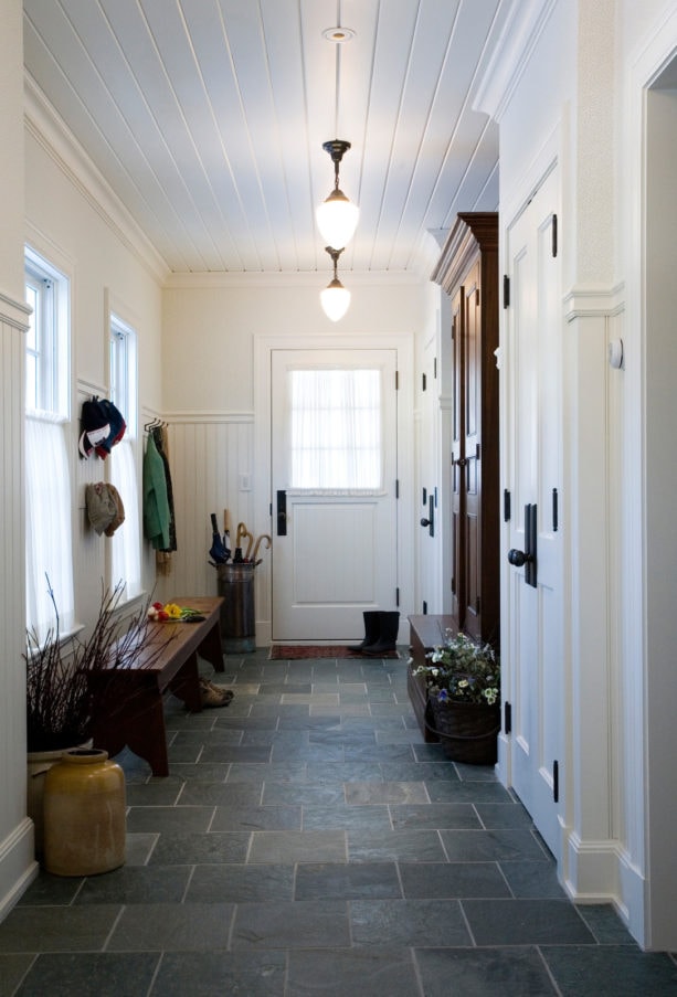 mid-century style small entryway with gray slate tile flooring