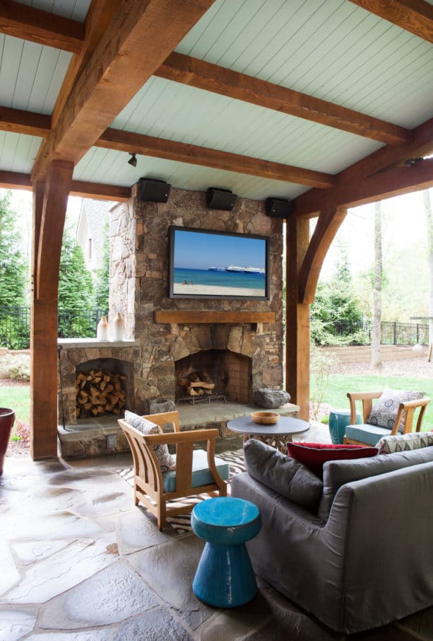 outdoor fireplace with built-in wood storage and tv for mid-sized traditional backyard