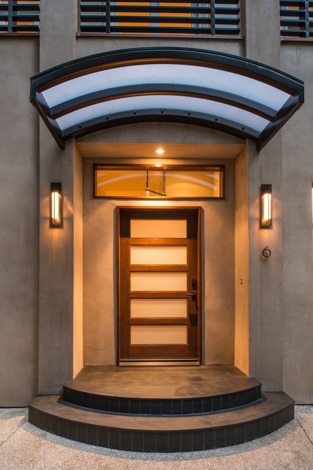 curved translucent awning attached to the wall at the top of the front door