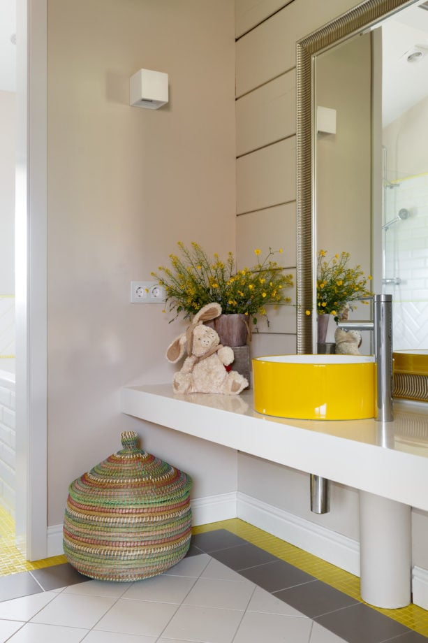 a round yellow sink in a contemporary warm grey bathroom