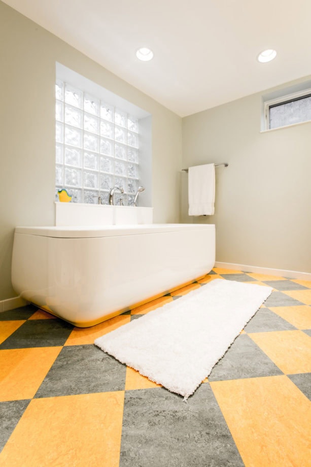 a unique grey and yellow floor in a transitional bathroom