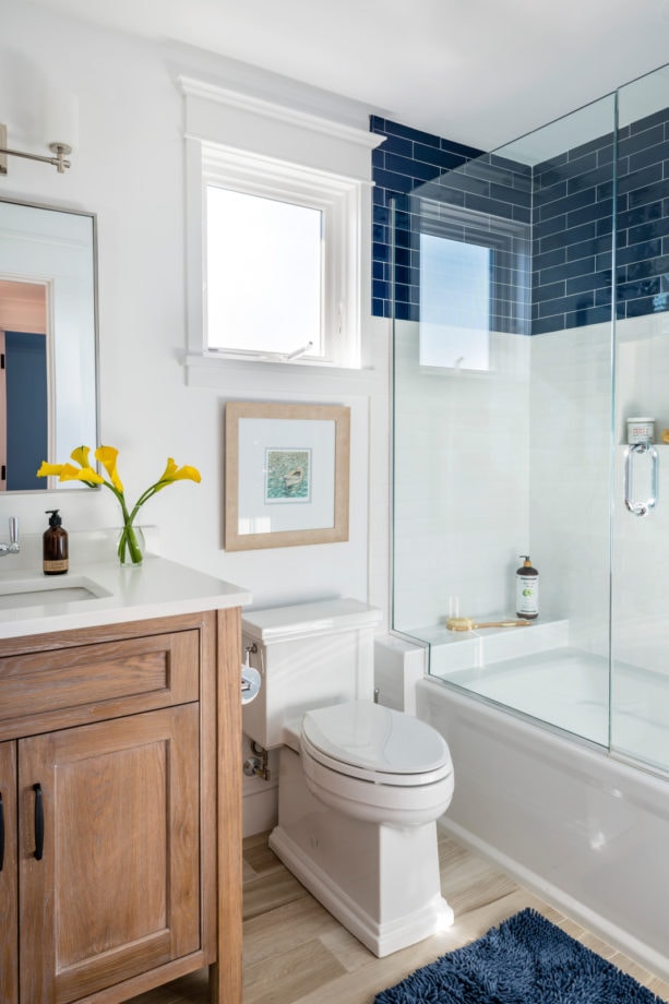 a beach-styled bathroom with a beautiful combination of blue and white tiles