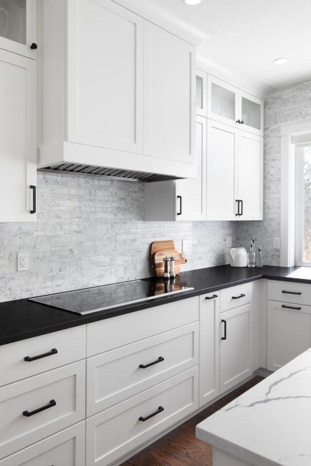 u-shaped shaker white cabinets and black granite countertops in a contemporary kitchen