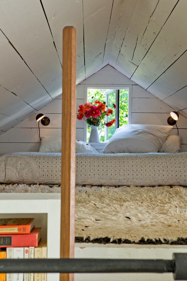 shabby-chic style attic bedroom with natural finish slanted walls