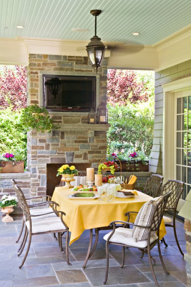 classic backyard and tile patio with fireplace and outdoor tv