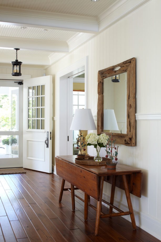 crisp white small entryway with walnut flooring